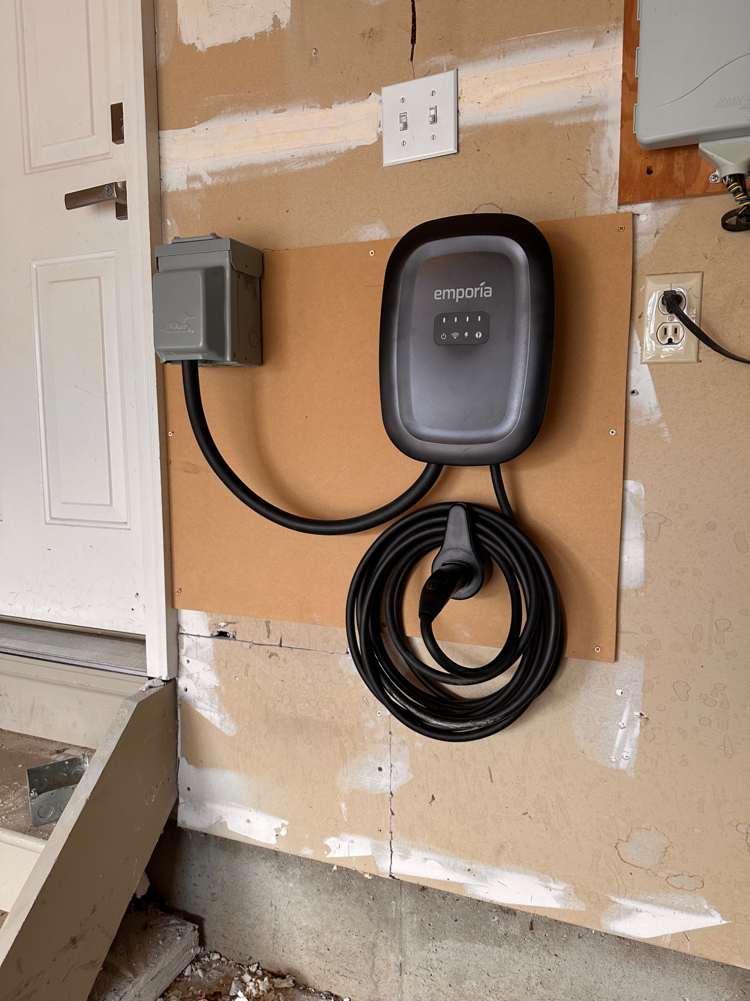 Emporia EV charger mounted on a garage wall by Day Electric
